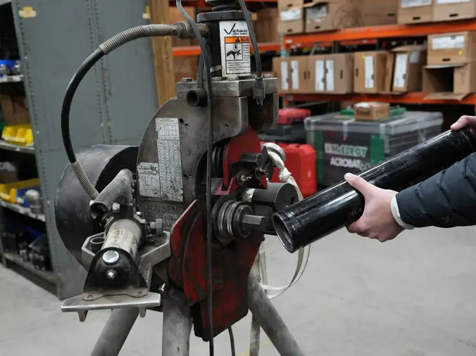Worker using plumbing machine at Hajoca Plumbing Supply Tulsa